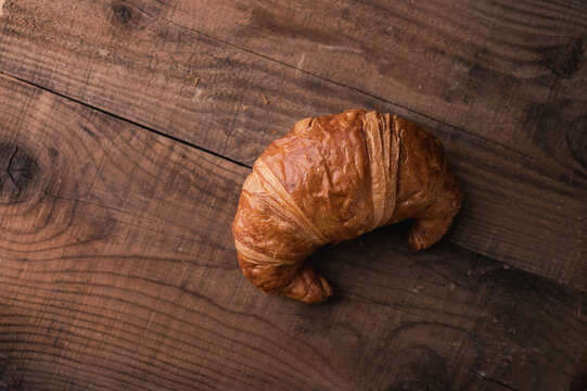 Freshly Baked Croasant on Wooden Plate
