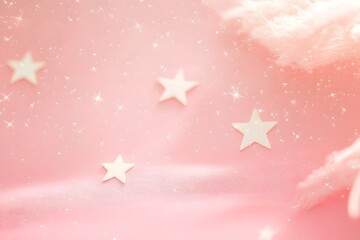 A dreamy pink background with stars and sparkles, creating a whimsical atmosphere.