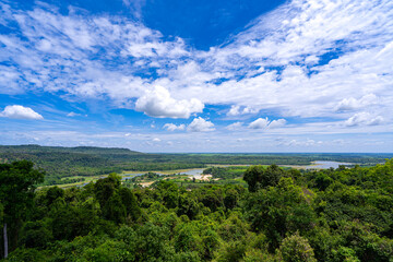 Obraz premium Overhead view. Lake in vast forest with a large area.There is decrease in amount of water. It appeared that a mound of land had turned into grass field. Which is both livestock area and agricultural.