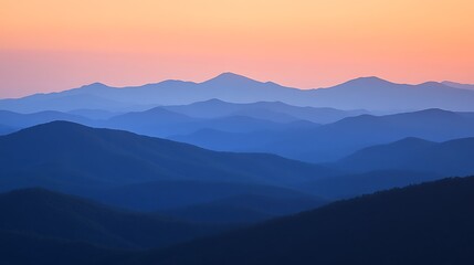 Serene mountain landscape at sunset, showcasing layers of hills and a gradient sky.