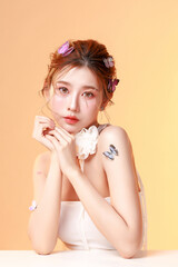 Elegant Asian Woman model with Butterfly Hair Accessories in Studio Portrait.