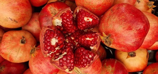 The pomegranate is cut into pieces and the quality of its inside is displayed to be shown to the customer.