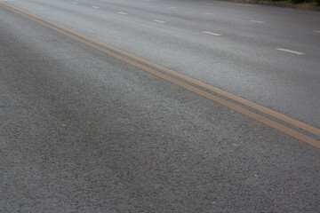 Road markings in Georgian city of Tbilisi. Yellow dividing line on asphalt. Double solid. Dedicated lane for public transport. Comfortable urban environment. Caring for people of city. Road sign