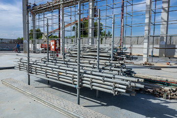 Stacked Metal Scaffolding Pipes at Construction Site