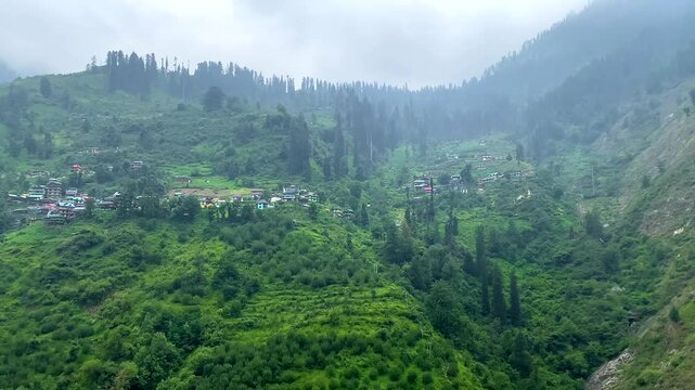Small villages and colorful local houses nested in the hills of parvati valley at manikaran, himachal pradesh, India.