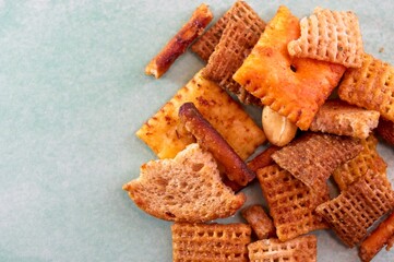 Close up of party mix with melba toast, pretzels and cereal squares