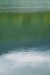 Obraz premium ฺBeautiful Reflected the sun rays hitting the water surface river is waves the sea surface before sunset natural background.