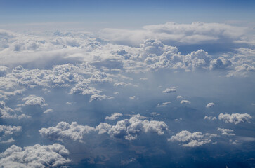 The sky is filled with clouds and the sun is shining through them