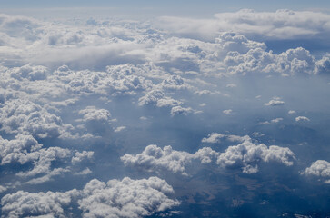 The sky is filled with clouds and the sun is shining through them