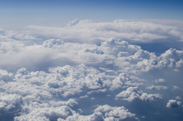 The sky is filled with clouds and the sun is shining through them