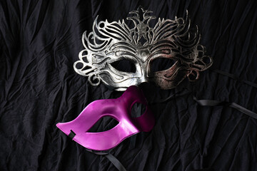 carnival vintage silver mask put on black cloth background.