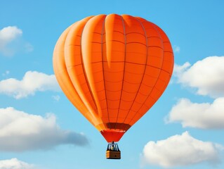 Fototapeta premium Vibrant orange hot air balloon soaring through a clear blue sky.
