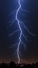 Stunning lightning striking through a dark sky over a silhouetted cityscape at night.