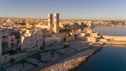 Fototapeta premium Aerial view old Mediterranean coastal city with big cathedral on sunny day, Molfetta, Puglia, Italy