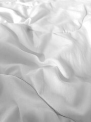 Obraz premium Crumpled white fabric. White fabric is the background. Shades of gray.