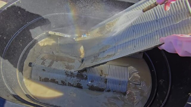 Cleaning swimming pool filter elements.