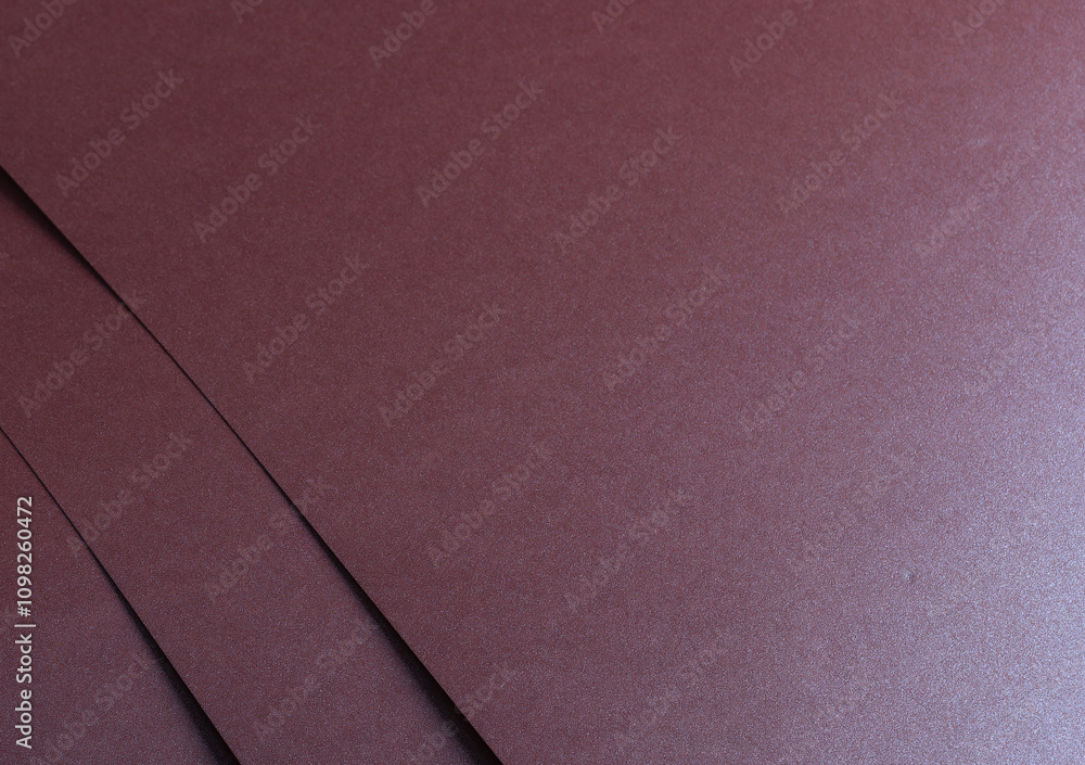 Poster metallic burgundy paper background with smooth, layered lines and a shimmering surface. featuring gl