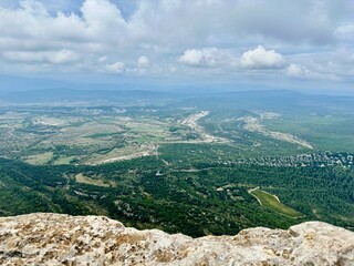 Aerial View from Pic Saint-Loup Overlooking The Giants Marches of Rouet, Surrounding Plains, and Col de Fambetou in Valflaunès, Near Montpellier, Under Partly Cloudy Skies