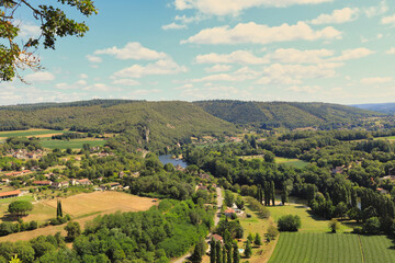 Obraz premium Lot Valley, France. The River Lot, a tributary of the Garonne, runs through green, preserved landscapes. Here you can find some of the most beautiful towns in France