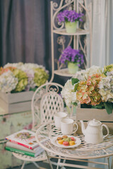 Afternoon tea with flowers and macarons