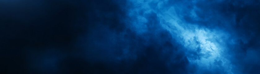 Blue abstract background featuring swirling fog like textures.