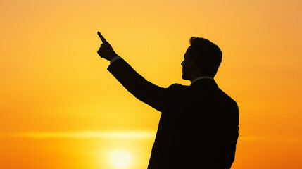 Fototapeta premium Businessman pointing finger at sunset, showing vision and leadership