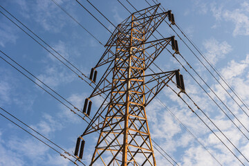 Power Lines. High-Voltage Electrical Tower. Transmission of Electricity. Metal High-voltage tower with high voltage wires and glass cups electro - insulators.

