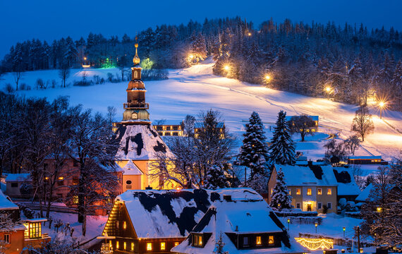 Enchanting Kurort Seiffen in Saxony, Germany at Christmas: Festive Ore Mountain Village with Snowy Landscapes, Illuminated Church, and Traditional Holiday Charm