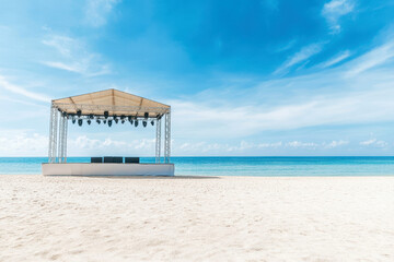 Naklejka premium Outdoor concert stage on a sandy beach with clear blue sky