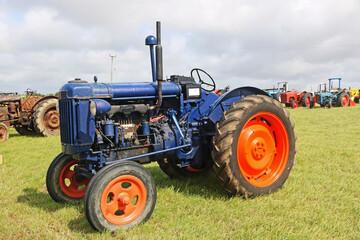 Obraz premium Vintage tractor standing in a field 