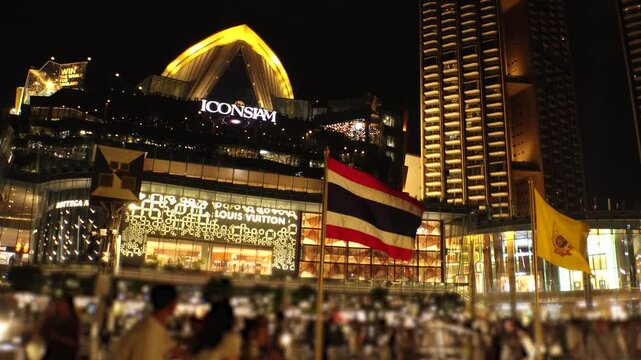 BANGKOK, THAILAND - AUGUST 2024 : View around Icon Siam shopping mall at night. Mixed-use development on the banks of the Chao Phraya river. 4K time lapse shot.