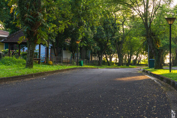 Obraz premium Complex Villa roads line trees with Pedestrian Activity leading to The Taman Dayu luxury housing complex in Pandaan village, Pasuruan, East Java, Indonesia. 