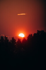 Setting sun and bright orange sky.