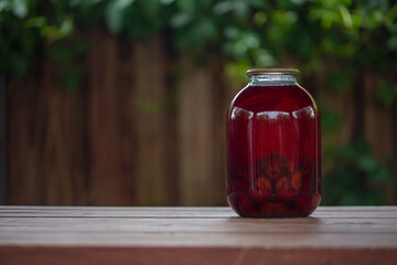 a glass jar with compote on the table