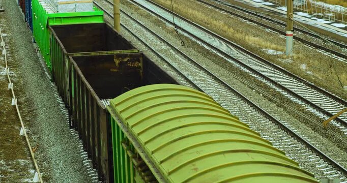 Cargo train. 60 fps 4k footage. of a railway tracks, wagons and wheels of a freight train. Delivery of cargo and goods all over the world. Long-distance freight transportation.