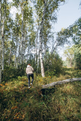 Girl walking in the forest in autumn