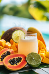Fototapeta premium A refreshing coconut water drink served with a slice of lime and tropical fruits