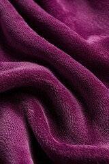 Fototapeta premium Rich purple velvet fabric with soft folds.