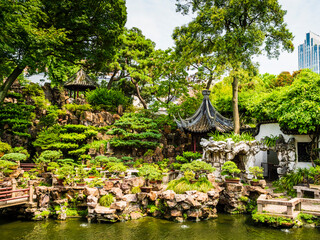 Stunning view of Yuyuan garden and one of its peaceful pond with traditional chinese architecture,...