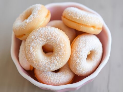 Ice suger coated dounuts in the white ceramic bowl