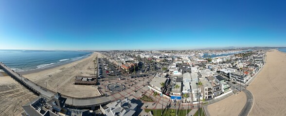 Newport Beach, California, November 20. 2024: New poer Beach, California, In Fall looking at kids at the piwe tht replaced the Mcfadden Wharf and the Pier Plaza from a UAV Drone
