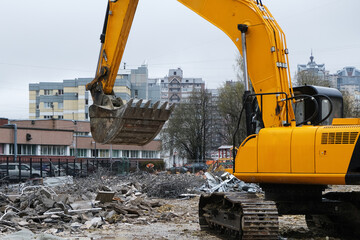 A construction site featuring an excavator set within an urban environment or area