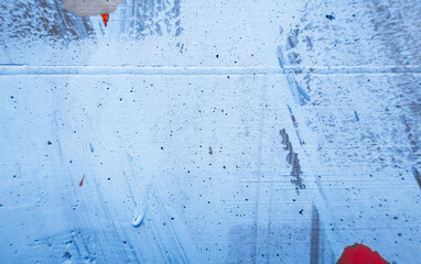 Old grunge stucco wall with messy paint strokes and smudges. Purple, red streaks of paint on...