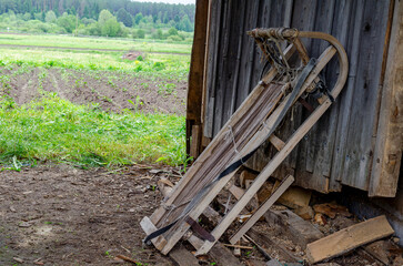 there is a wooden sleigh with a stretched rope. Wooden large sleigh for transportation.