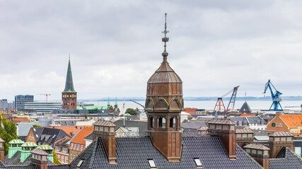 Skyline of Aarhus, Denmark, with the copper-topped towers and spire of historic buildings set...