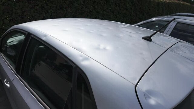 car body damaged by hail. hail damage on car
