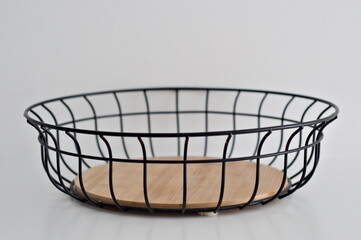 Obraz premium Metal fruit basket with wooden insert isolated on white background