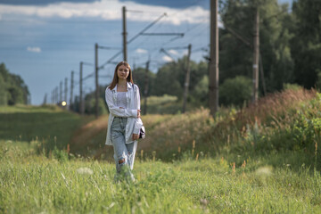 Young beautiful girl in a summer park in nature.