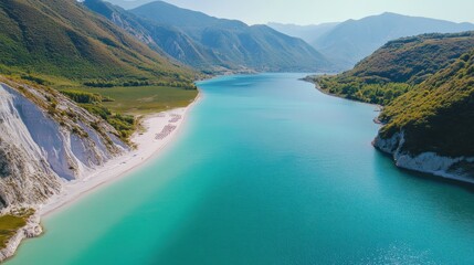 Obraz premium Aerial View of Turquoise Lake and Sandy Beach in Mountains