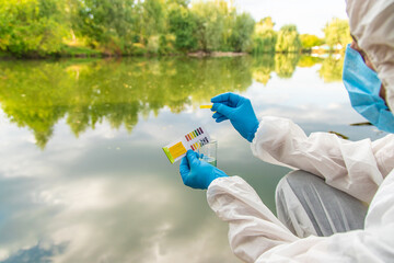 Take water samples for analysis. Selective focus.